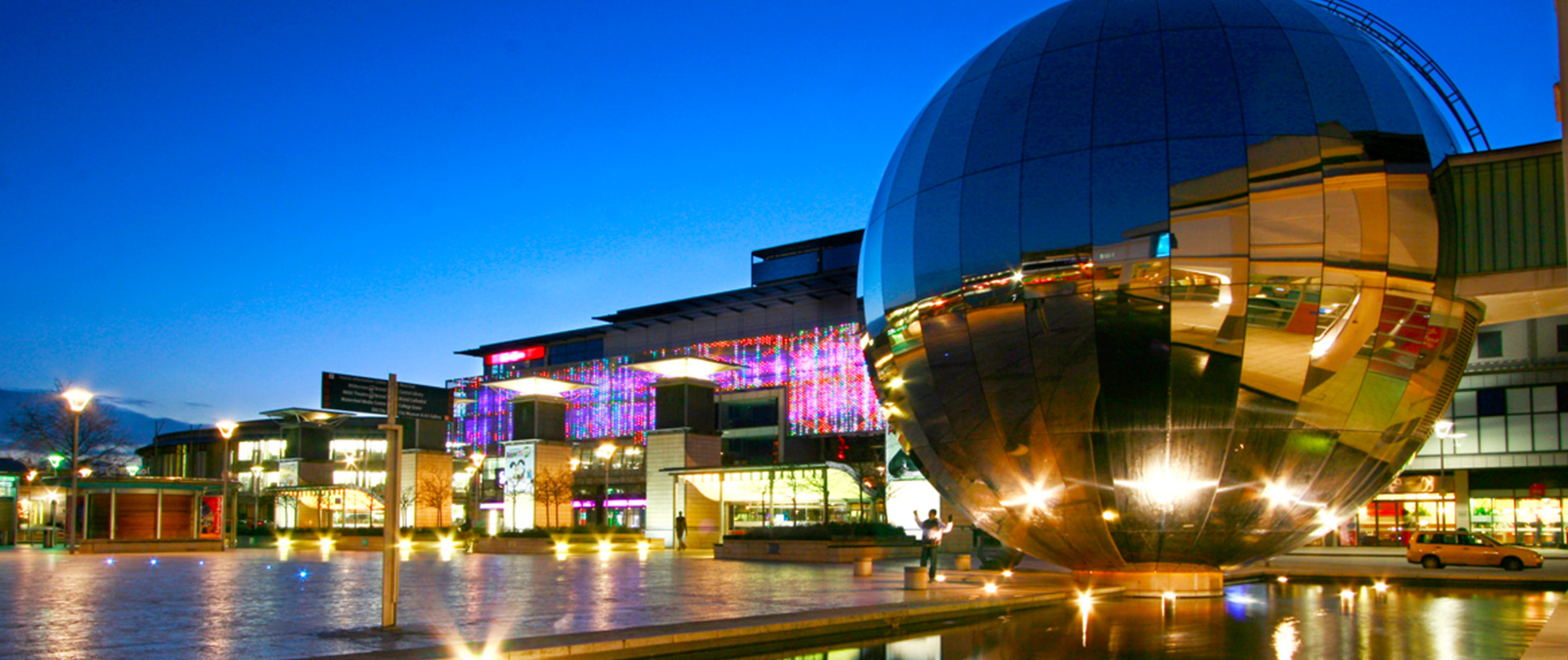 Millennium Square Bristol Harbour An evening view of Millennium Square showing the planetarium ball, a large mirrored ball which is part of the city's science museum.